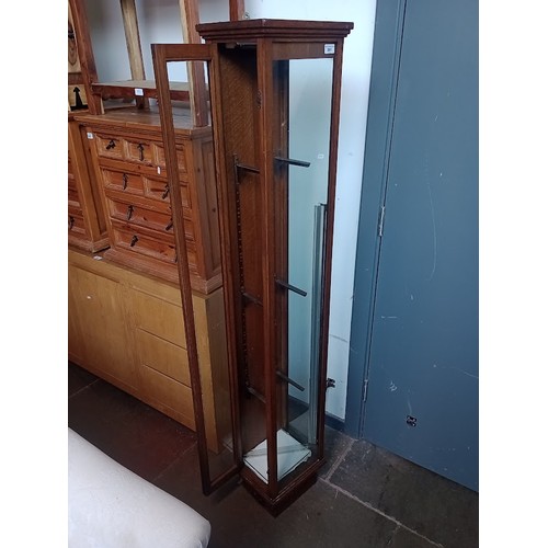 891 - An early 20th century oak and glass elongated shop display cabinet.