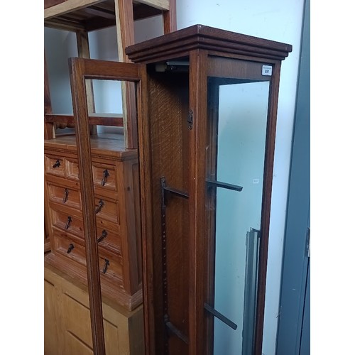 891 - An early 20th century oak and glass elongated shop display cabinet.