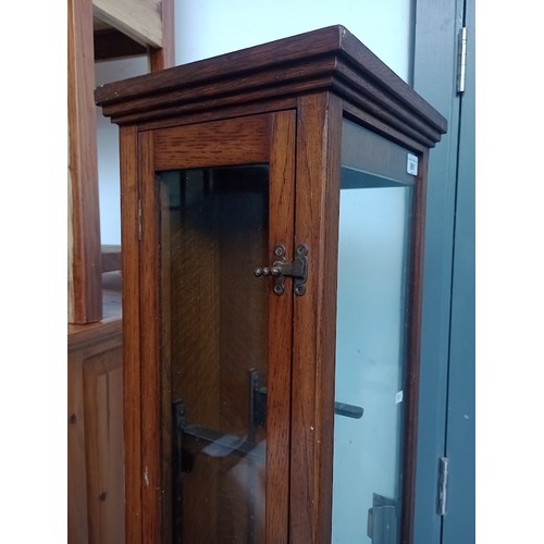 891 - An early 20th century oak and glass elongated shop display cabinet.