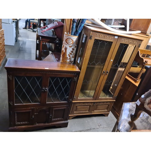 949 - An oak and leaded glass display cabinet and an oak and leaded glass bookcase.