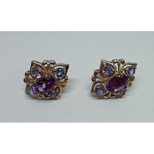 10 - A pair of 9ct gold amethyst and tanzanite earrings, gross weight 2.43 grams.