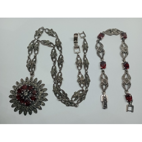 12 - A marcasite and garnet set pendant marked 925 with similar bracelet, gross weight 1.9 ozt.