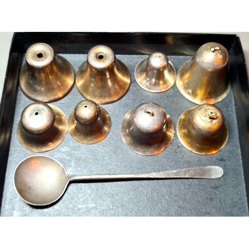 31 - A set of silver bells and a silver spoon, various marks, gross weight 3.9 ozt.