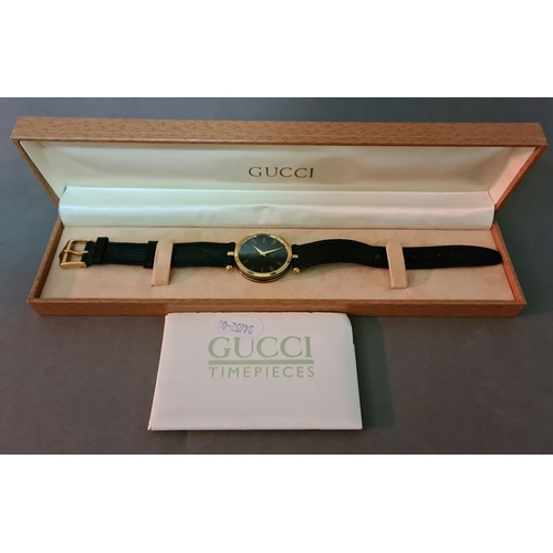 45 - A vintage 1990s Gucci Stack 2000M gold plated watch with enameled back, with papers and box.
