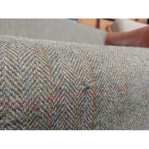 1058 - A Harris tweed and tan leather two seater sofa.