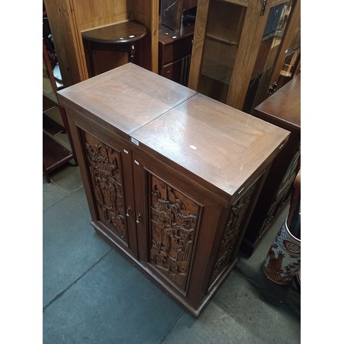 963 - A Chinese carved wood fold out cocktail cabinet/ bar.