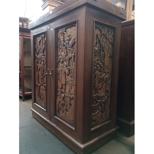 963 - A Chinese carved wood fold out cocktail cabinet/ bar.