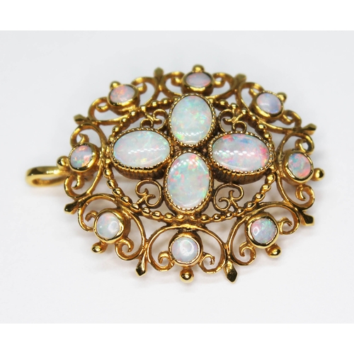 1 - An opal pendant brooch, four central millegrain set oval opal cabochons surround by eight bezel set ... 