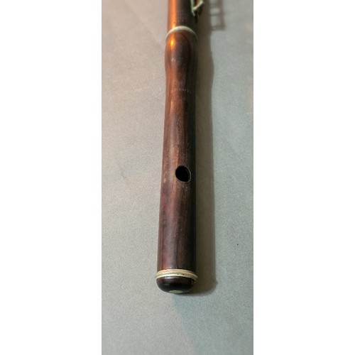 139 - An antique rosewood flute in leather case.