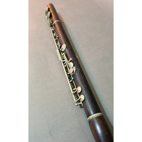 139 - An antique rosewood flute in leather case.