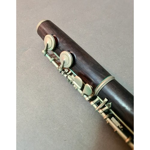 139 - An antique rosewood flute in leather case.