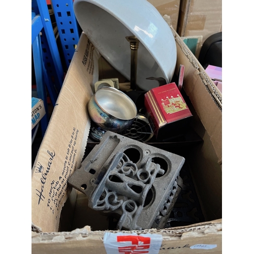 175 - A box of metalware to include trivets, brass candlesticks, old tins, etc.