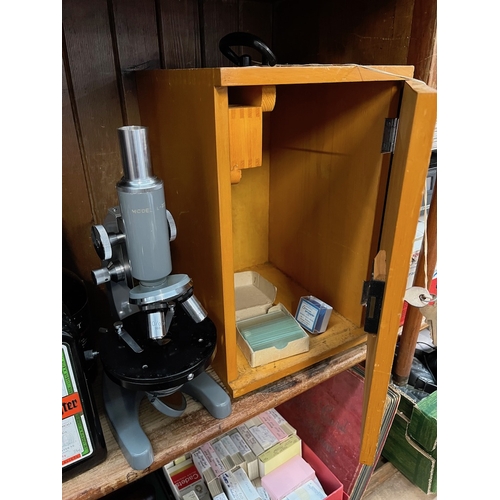 29 - A vintage microscope model L-201 in wooden box together with extra lenses.