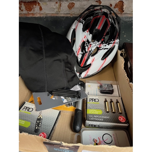 290 - A box of bicycle accessories to include helmet, CO2 inflator with cartridges, light set, etc.