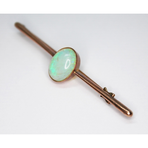 72 - An antique opal cabochon brooch, the millegrain set opal measuring approx. 12mm x 9mm, unmarked, gro... 