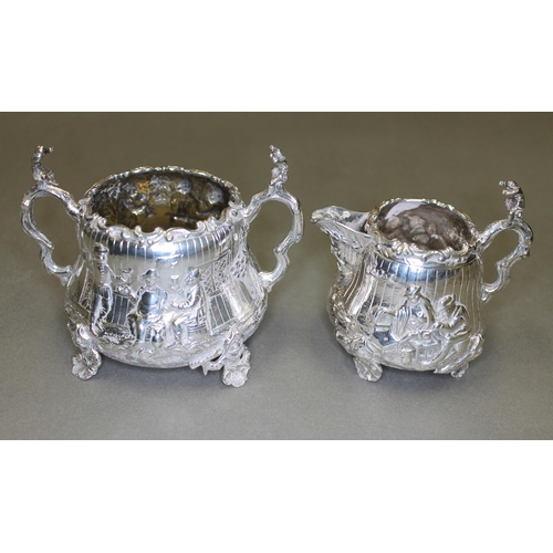 151 - A Victorian matched four piece silver tea set, decorated all over with in repousse depicting joyful ... 