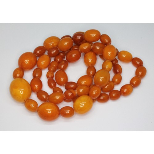 36 - A butterscotch pressed amber bead necklace, the beadsing ranging in length from approx. 8mm to 21mm,... 