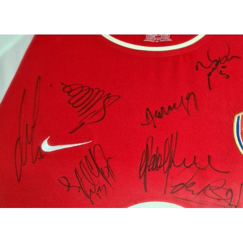 274 - A signed Arsenal f.c. shirt, a signed photo of Alan Shearer with other photos and a hutton youth tea... 