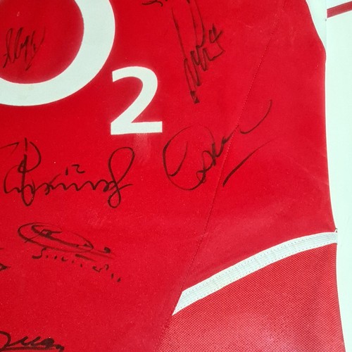 274 - A signed Arsenal f.c. shirt, a signed photo of Alan Shearer with other photos and a hutton youth tea... 