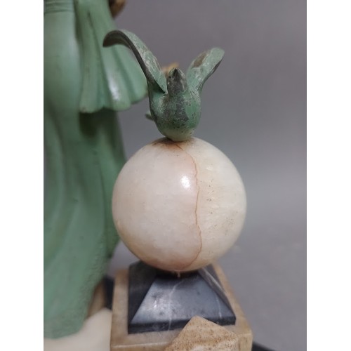 229 - An Art Deco cold painted spelter figure of a lady holding a dove on marble base.