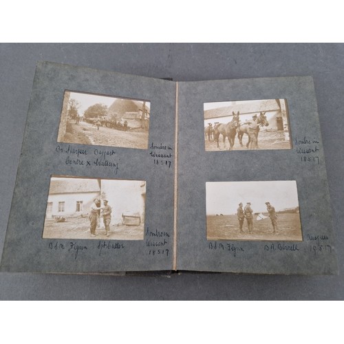 220 - A small album of military photographs from 1917 together with a Bible.