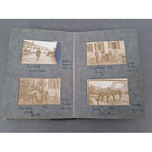 220 - A small album of military photographs from 1917 together with a Bible.