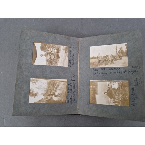 220 - A small album of military photographs from 1917 together with a Bible.