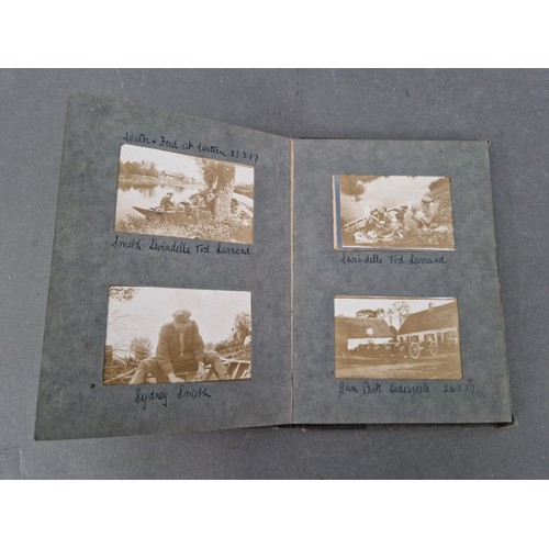 220 - A small album of military photographs from 1917 together with a Bible.