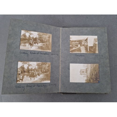 220 - A small album of military photographs from 1917 together with a Bible.