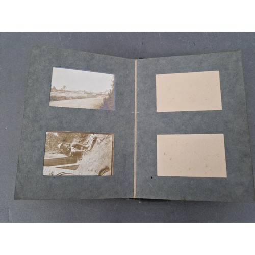 220 - A small album of military photographs from 1917 together with a Bible.