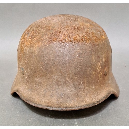 249 - A WW2 German M42 military steel helmet with some remnants of original paint on surface.