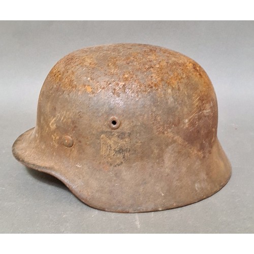 249 - A WW2 German M42 military steel helmet with some remnants of original paint on surface.