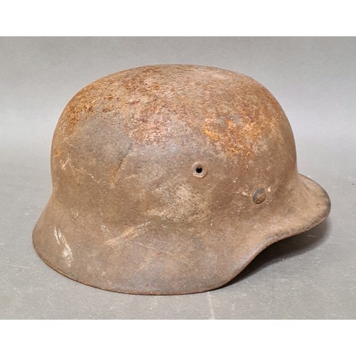 249 - A WW2 German M42 military steel helmet with some remnants of original paint on surface.