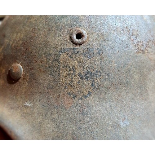 249 - A WW2 German M42 military steel helmet with some remnants of original paint on surface.