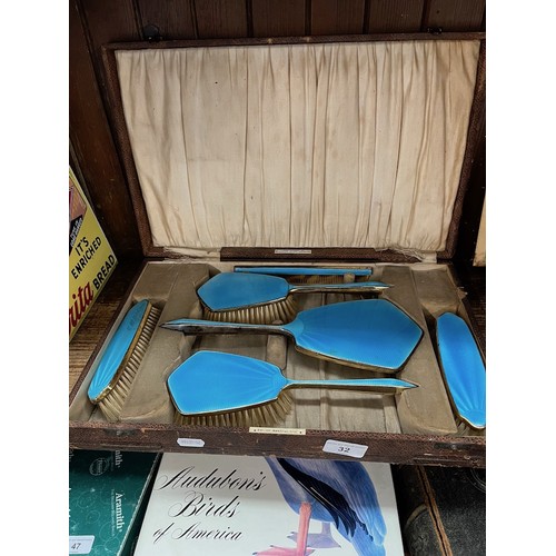 32 - A cased blue enamel vintage dressing table set.