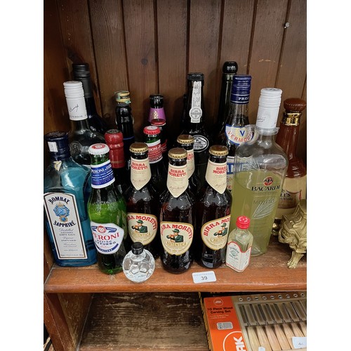 39 - A collection of alcoholic beverages including bottles of beer, spirits etc.