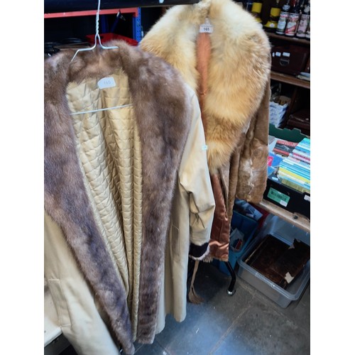 165 - A fur coat and a vintage trench coat.