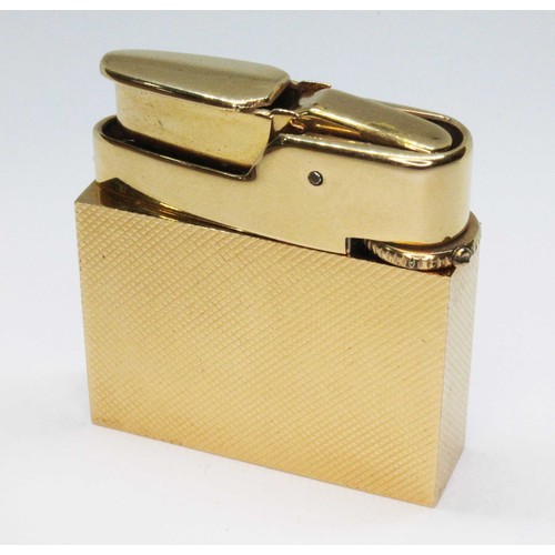 5 - A Fred Manshaw textured gold cased gas lighter, marked 'FM' within a heart and '9.375', gold wt. 18.... 