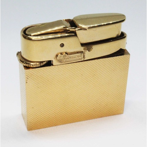 5 - A Fred Manshaw textured gold cased gas lighter, marked 'FM' within a heart and '9.375', gold wt. 18.... 