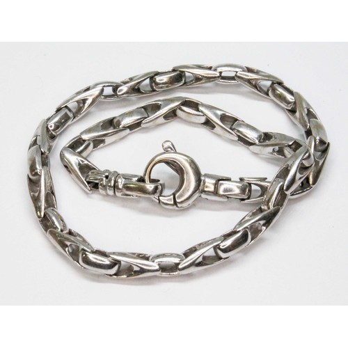 33 - A modern white metal bracelet with lobster claw clasp, marked '18Kt', length 22.5cm, wt. 17.6g.