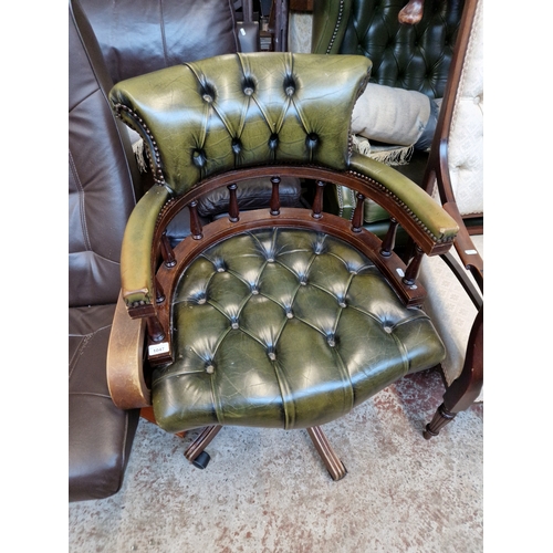 1047 - A green leather Chesterfield captain's chair.