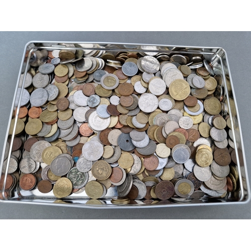 4 - A tin ofassorted world coins.