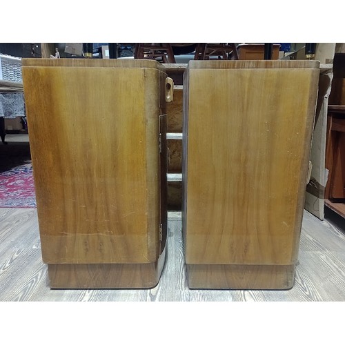 142 - A pair of Art Deco figured walnut bedside cabinets, height 67cm.