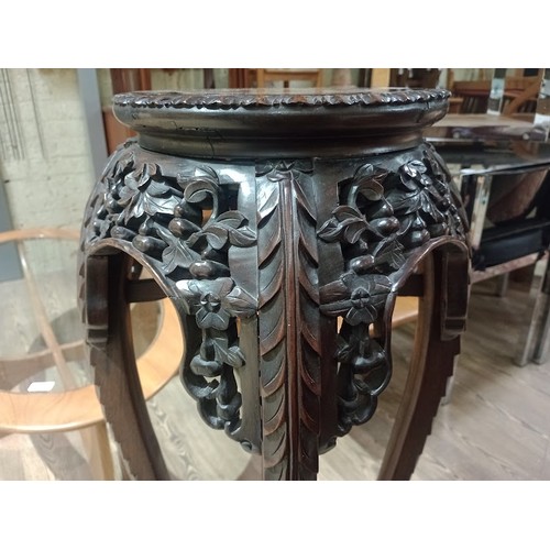 141 - A Chinese carved hardwood and marble top plant stand, 19th century, height 91cm.