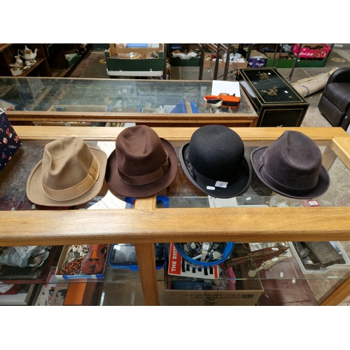 3 - Three trilby hats and a bowler hat, all by Dunn & Co, together with a fox fur coat