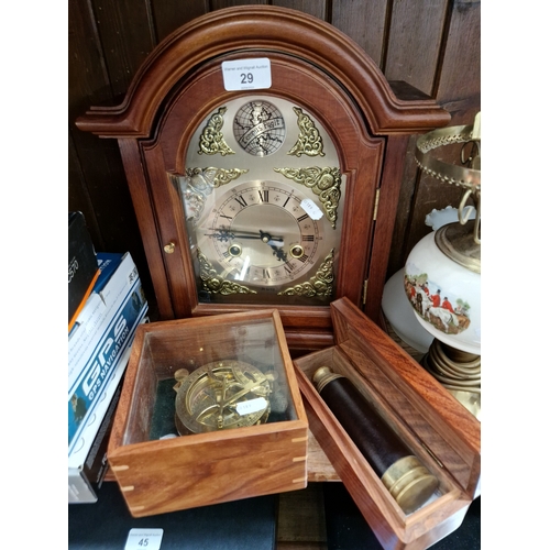 29 - A 31 day mantle clock with key, a reproduction brass compass in wood/glass case, and a reproduction ... 