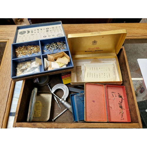 35 - A box of assorted watch parts.