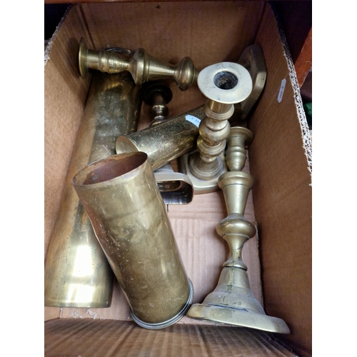 51 - A box of brass shell cases and candlesticks.