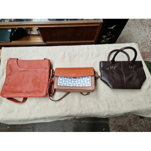 72 - Two Radley handbags with sleeves and a Barbour leather handbag.