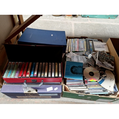 95 - 2 boxes of CDs, music cassettes, reel to reel tapes, DVDs etc